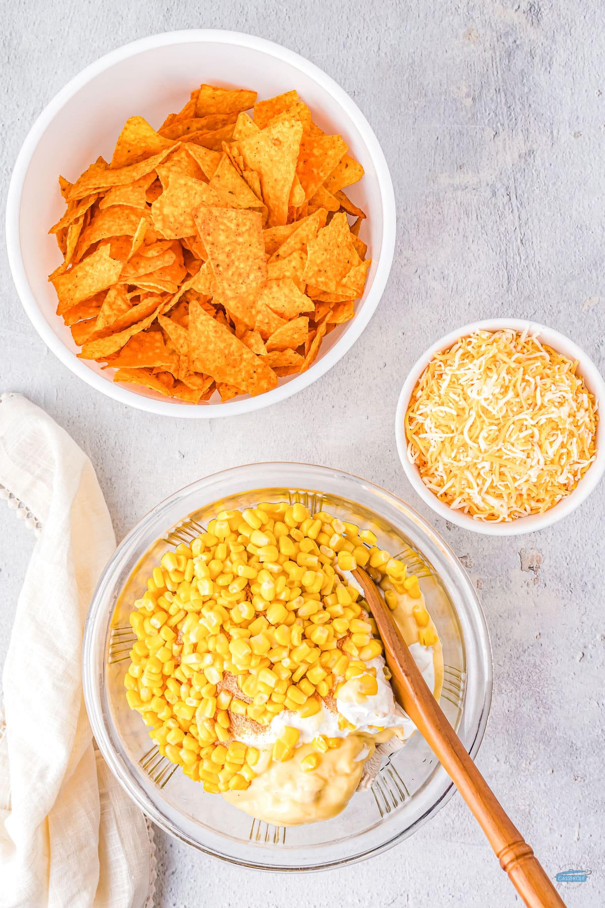 corn in a bowl with wood spoon