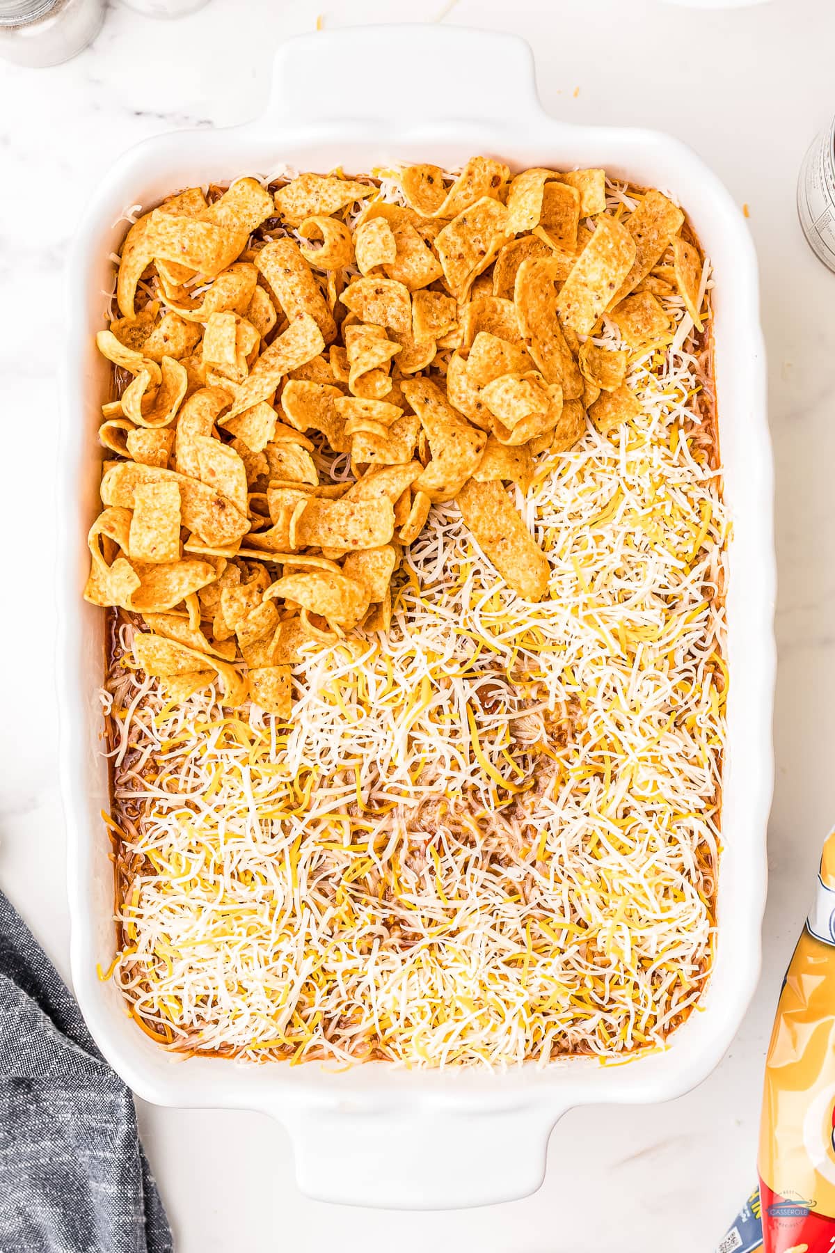 casserole topped with shredded cheese and corn chips