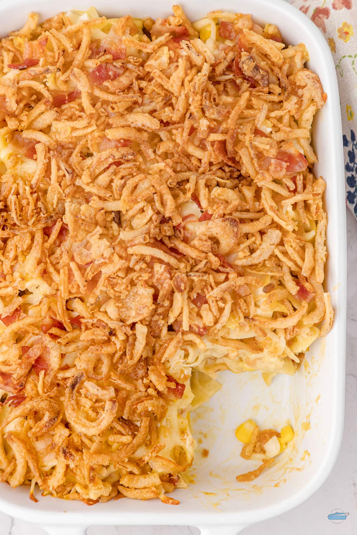 comforting chicken noodle casserole with scoop missing