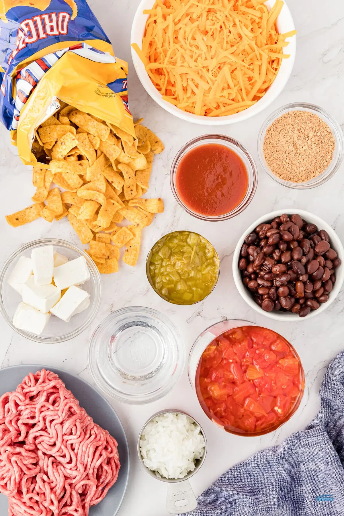 ingredients for walking taco bake in individual bowls