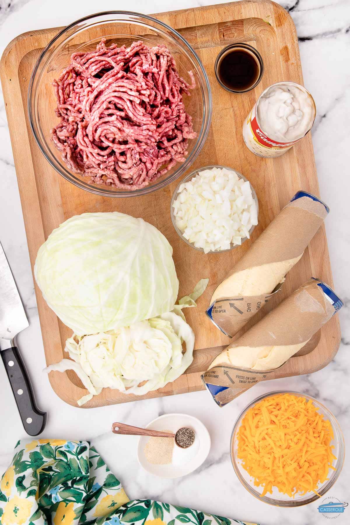 yellow onion, ground beef and cabbage on a board