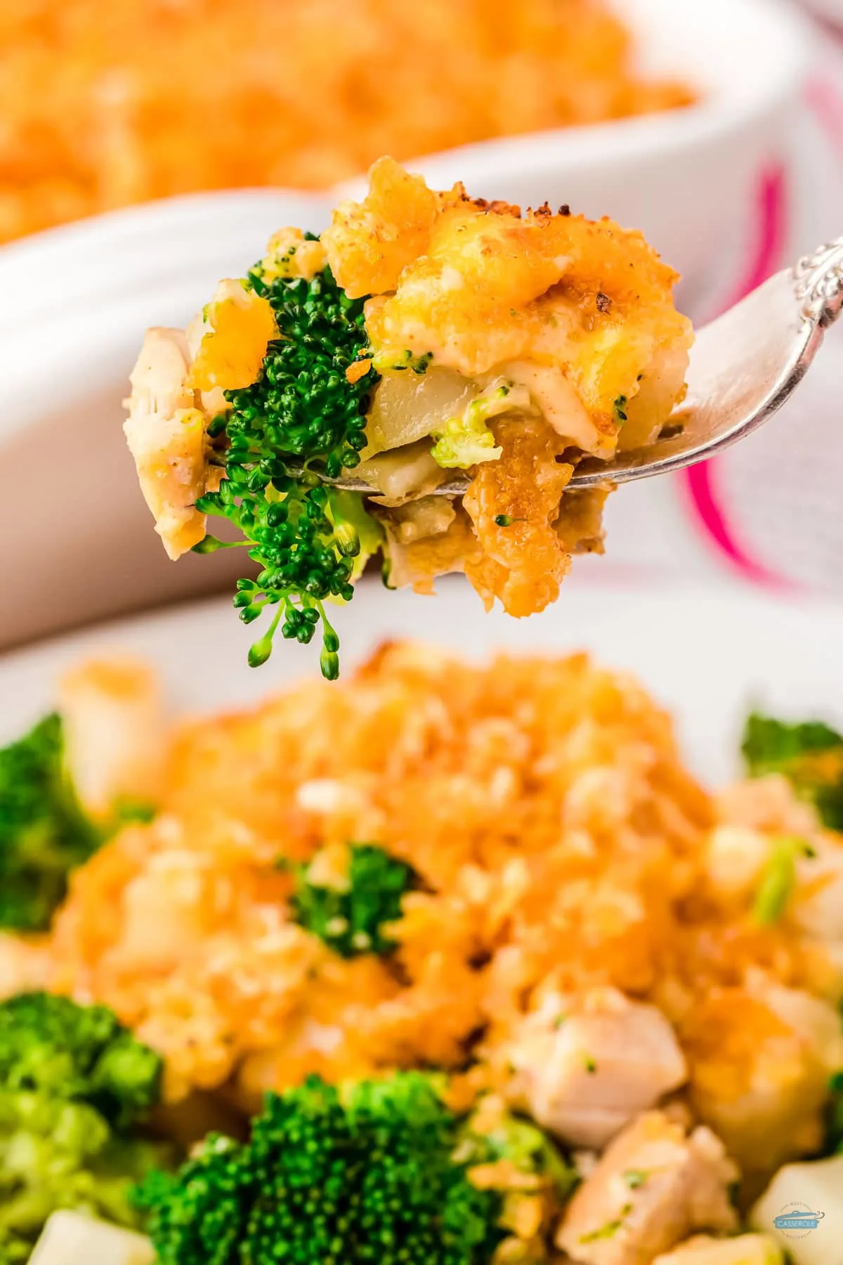 fork holding a bite of chicken broccoli potato casserole which is an easy recipe