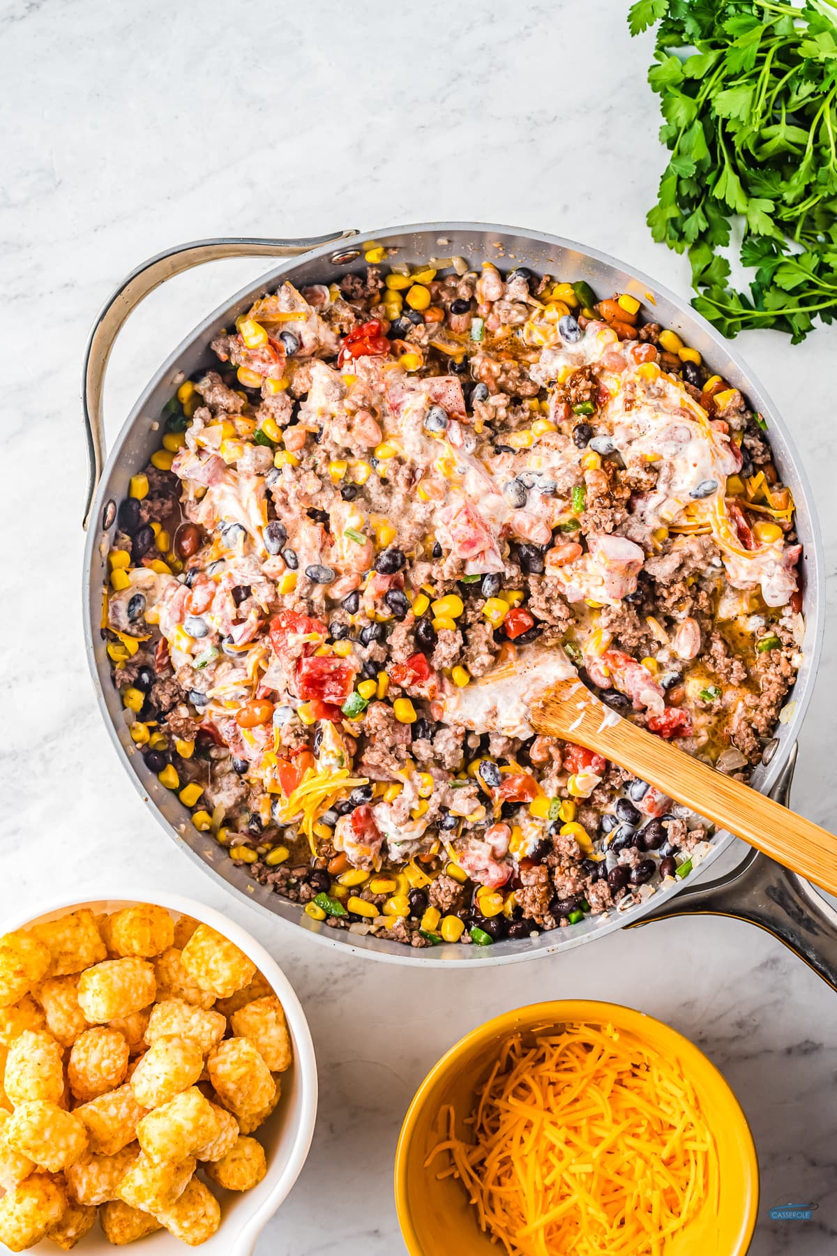 skillet with meat, beans, and sour cream