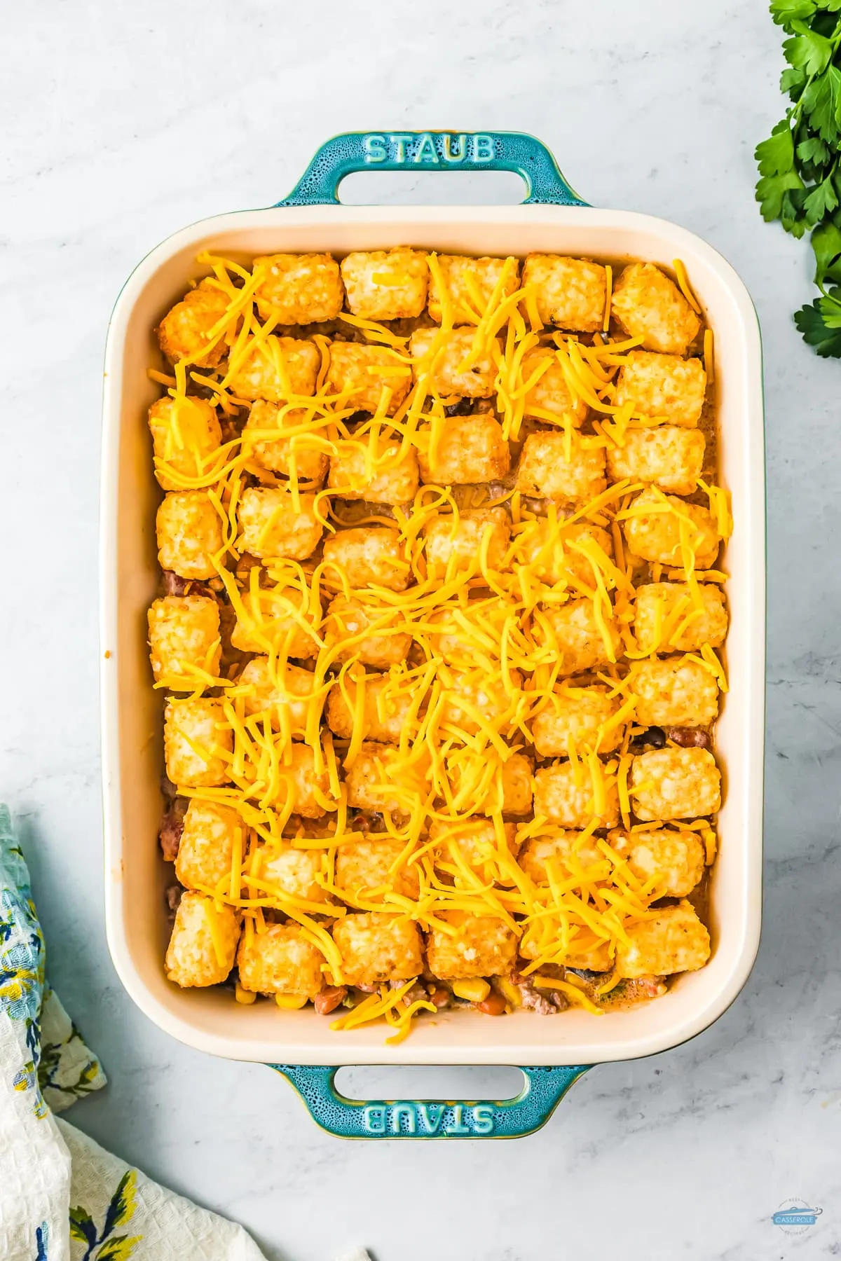 tater tots and cheese in a casserole dish
