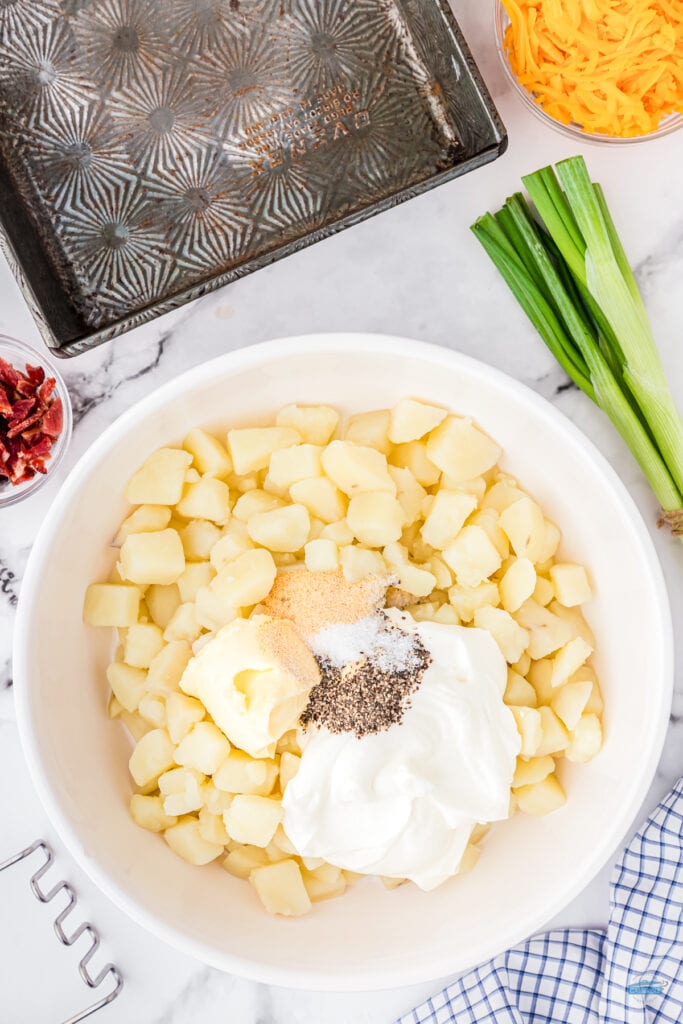 cooked potatoes and sour cream in a bowl