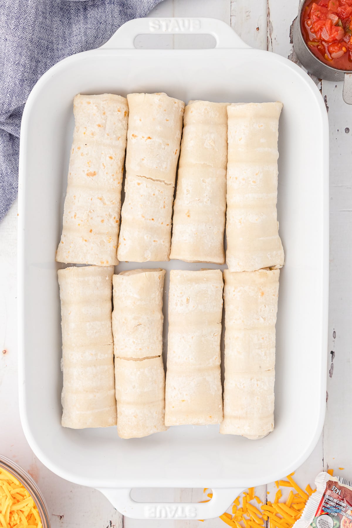 unwrapped frozen burritos in a white dish