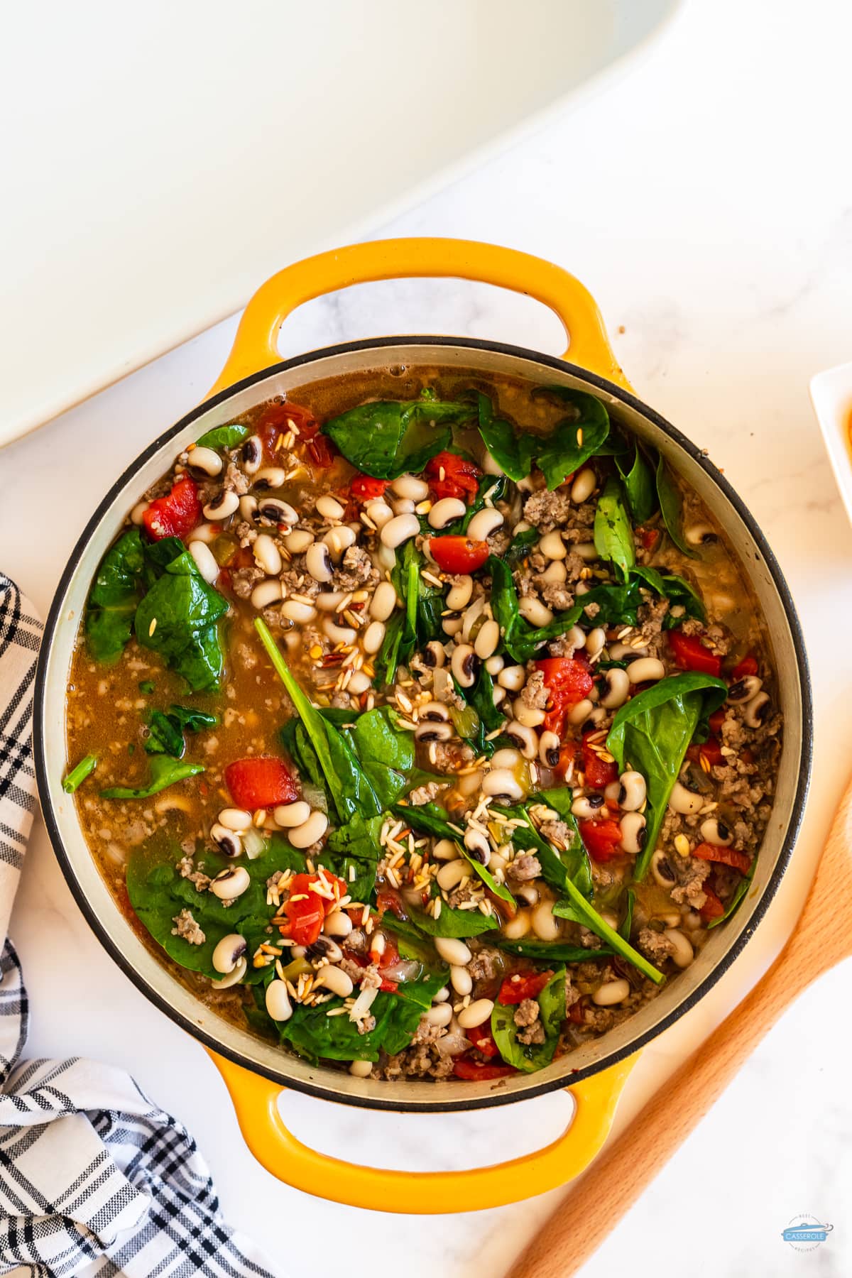 pot of soup with beans and fresh spinach
