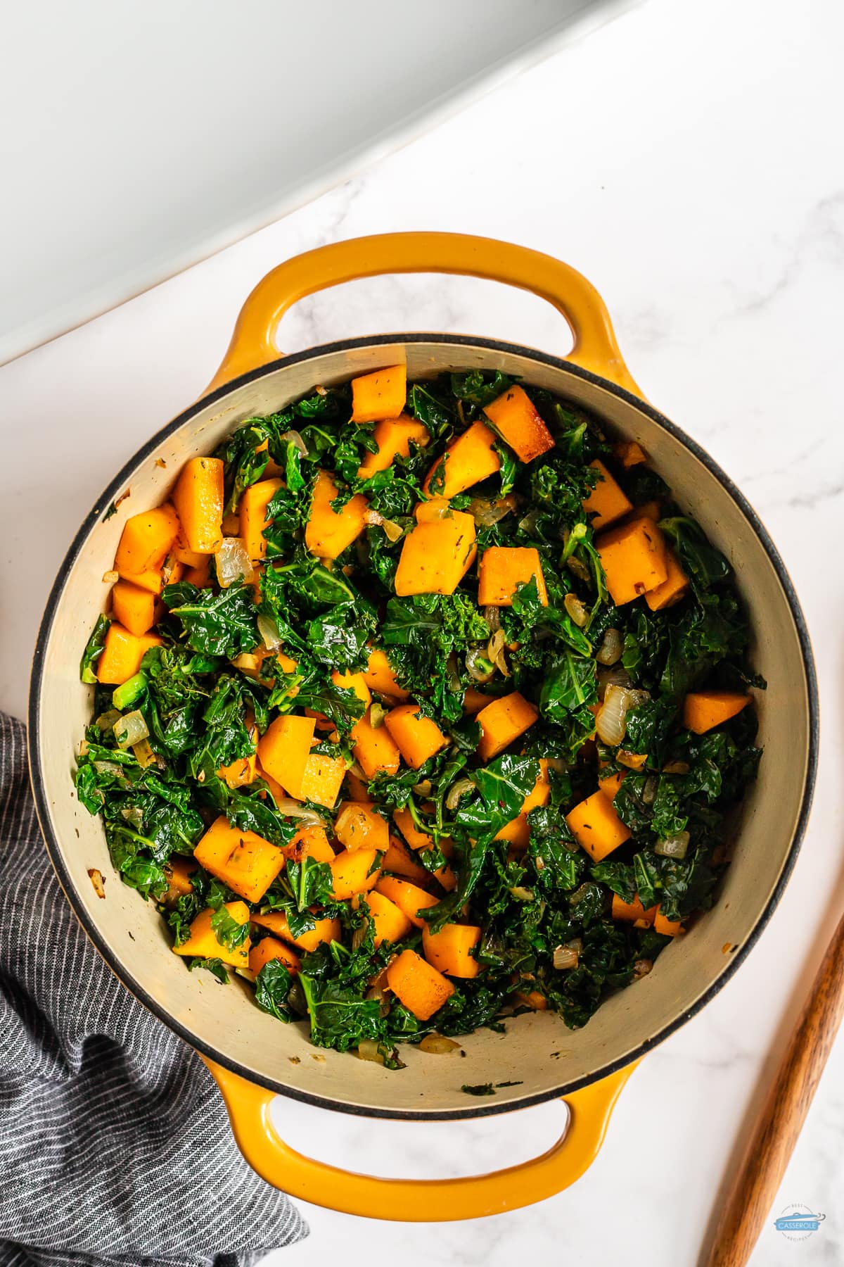 kale and squash in a yellow pot