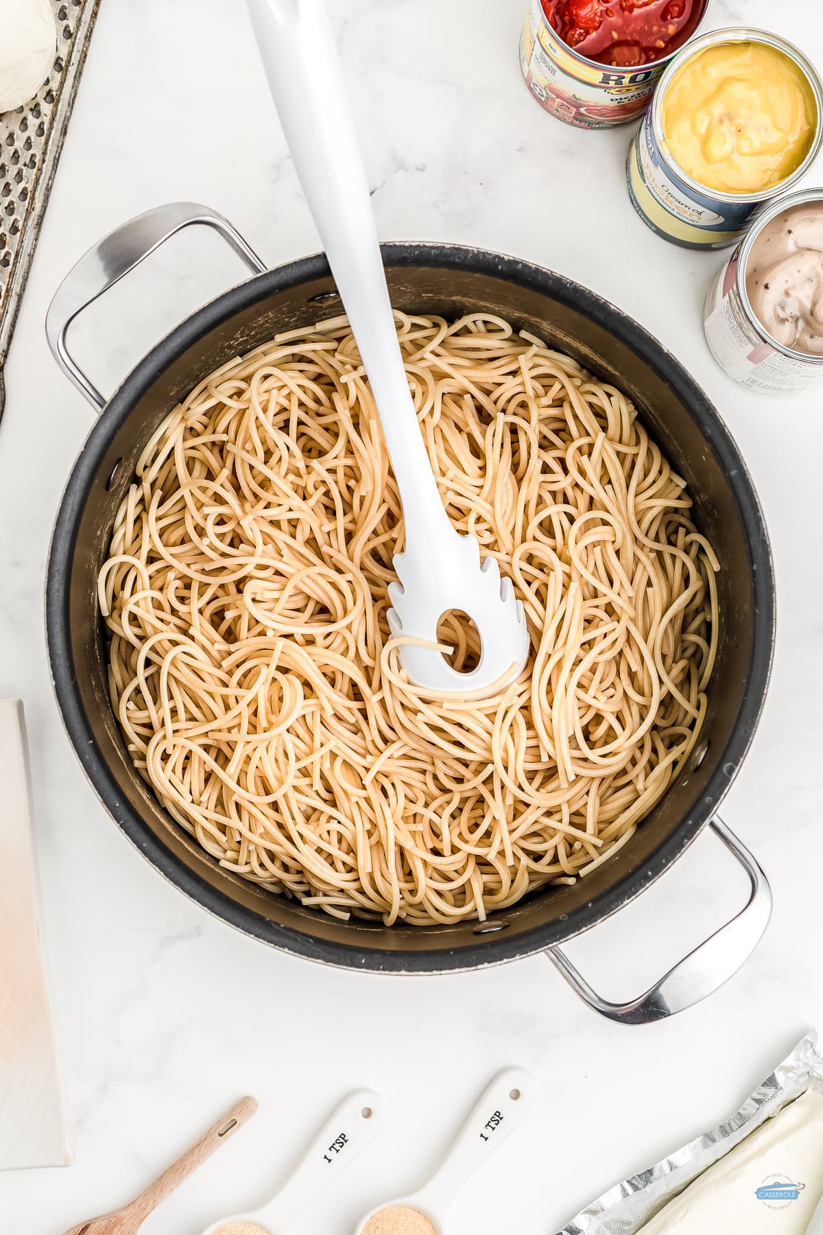 spaghetti in a pot with a white fork