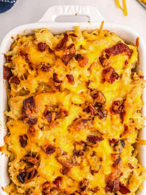 white casserole dish with hashbrowns and bacon