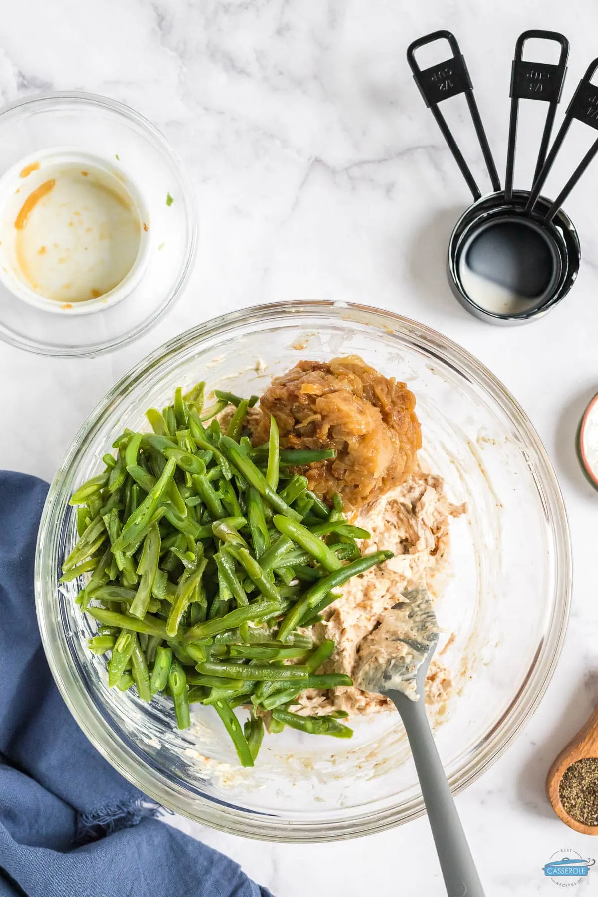 chicken mixture and green beans in a clear bowl