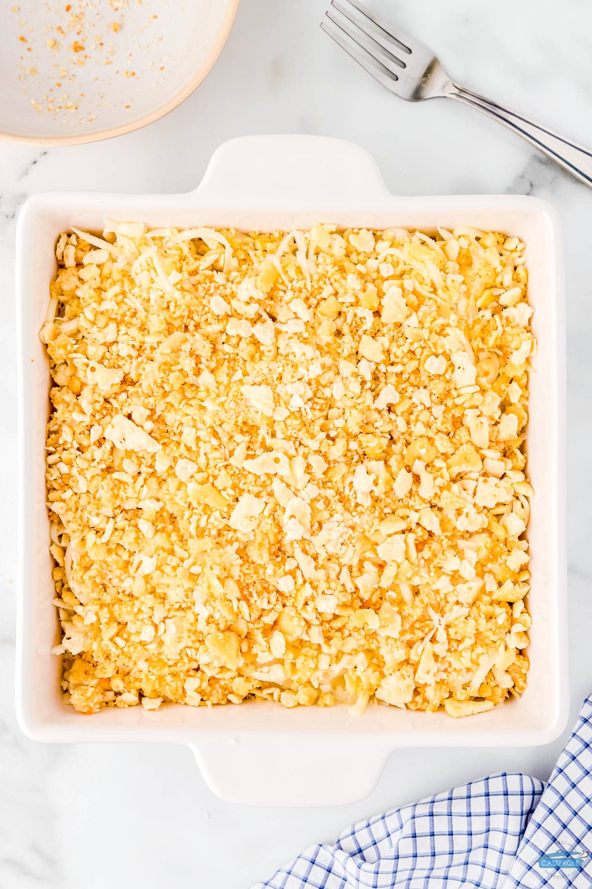unbaked onion casserole in a square white dish