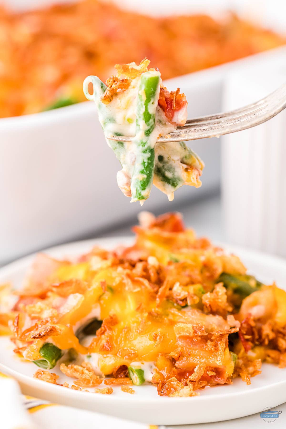 bite of casserole with green beans on a fork