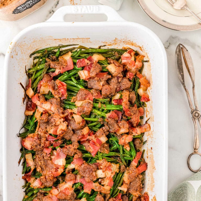 casserole in a white rectangle dish with tongs