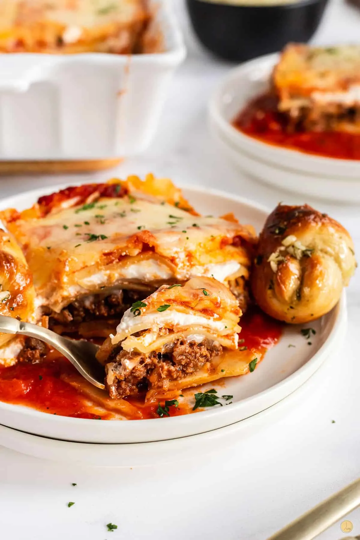 fork of lasagna on a white plate