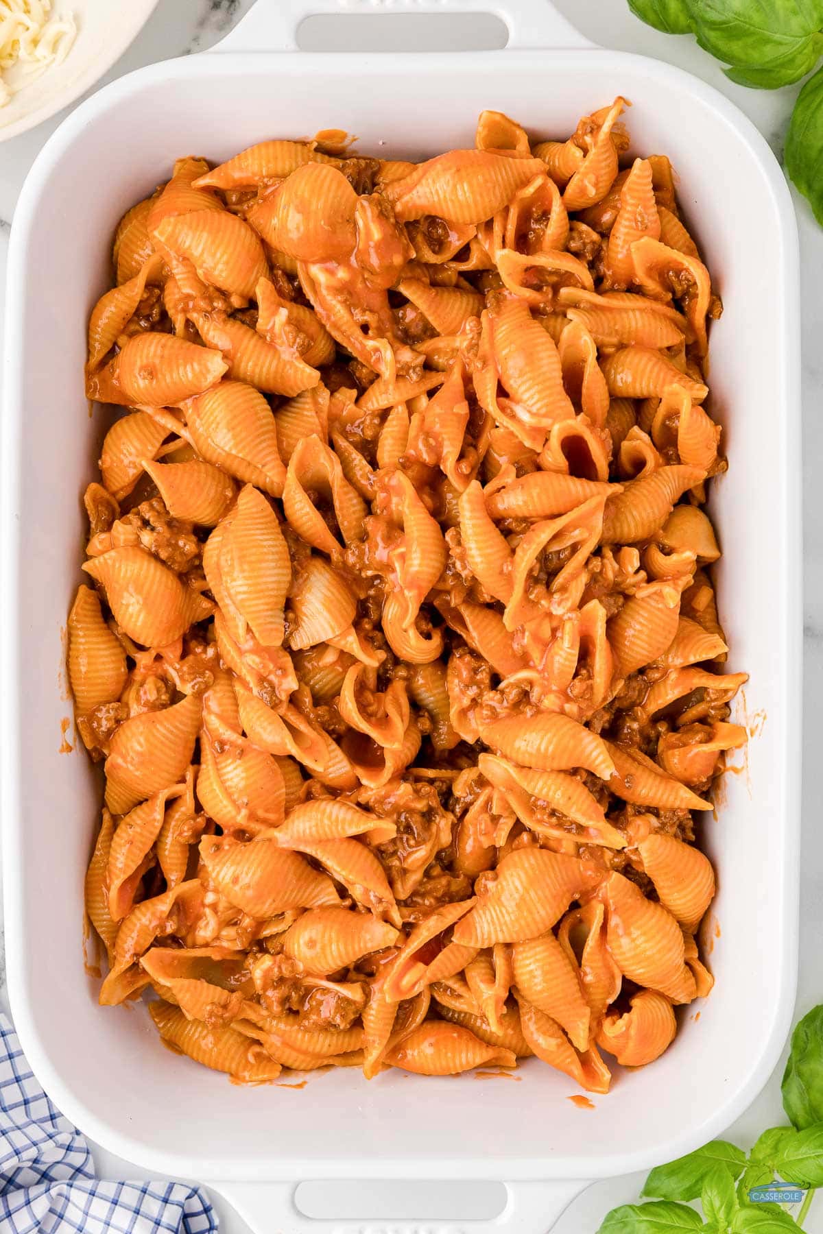 unbaked pasta casserole in a white dish