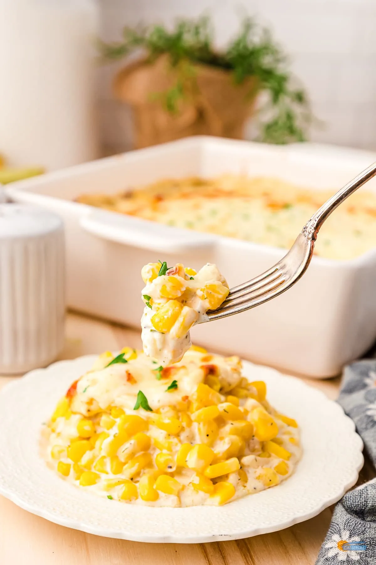 fork with corn casserole on it over a plate