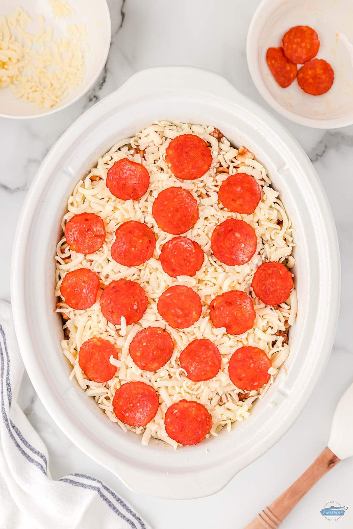slow cooker pizza casserole uncooked in a white bowl