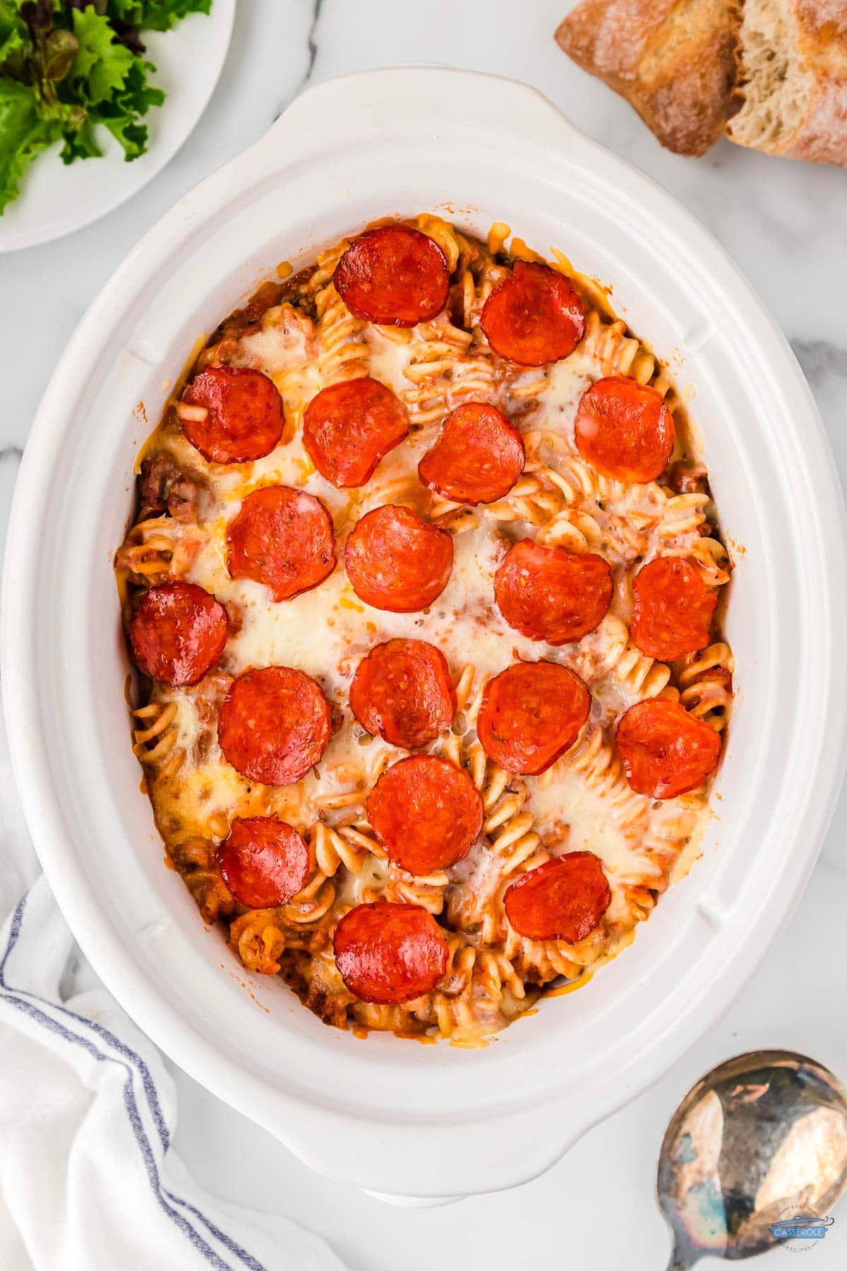 cooked crockpot pizza casserole topped with pepperoni