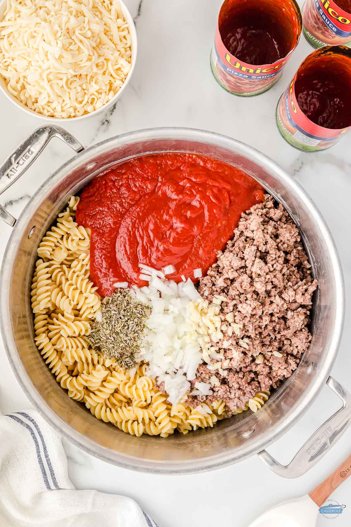 pasta, sauce, spices, and meat in a pot