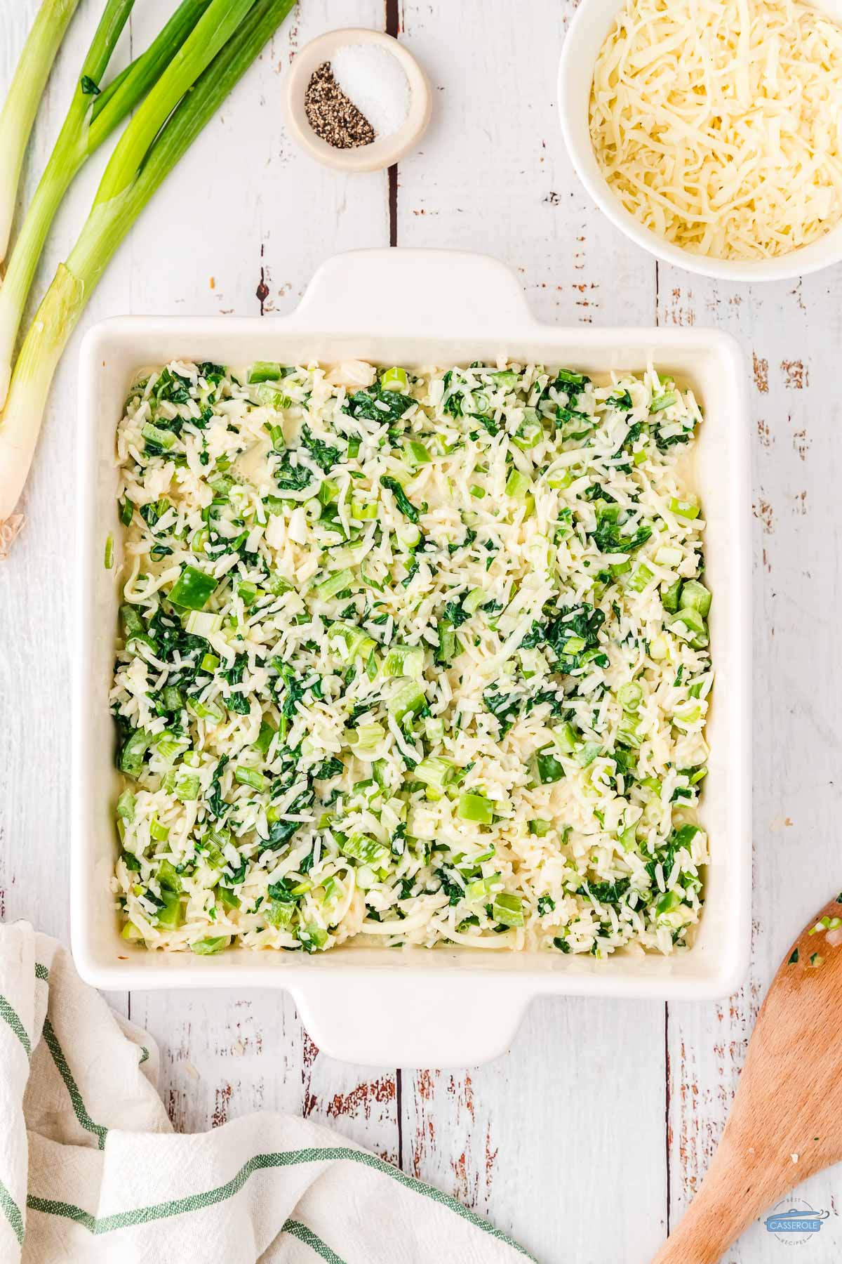 unbaked green rice casserole in a square dish