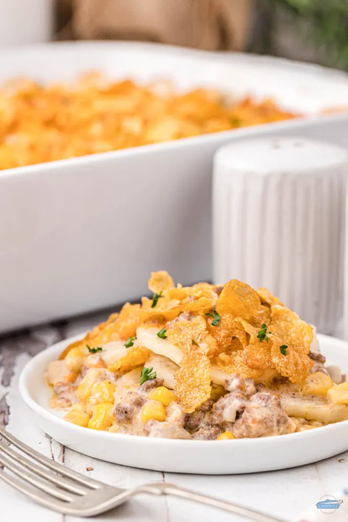 plate of hamburger potato casserole with salt and pepper shakers in the background
