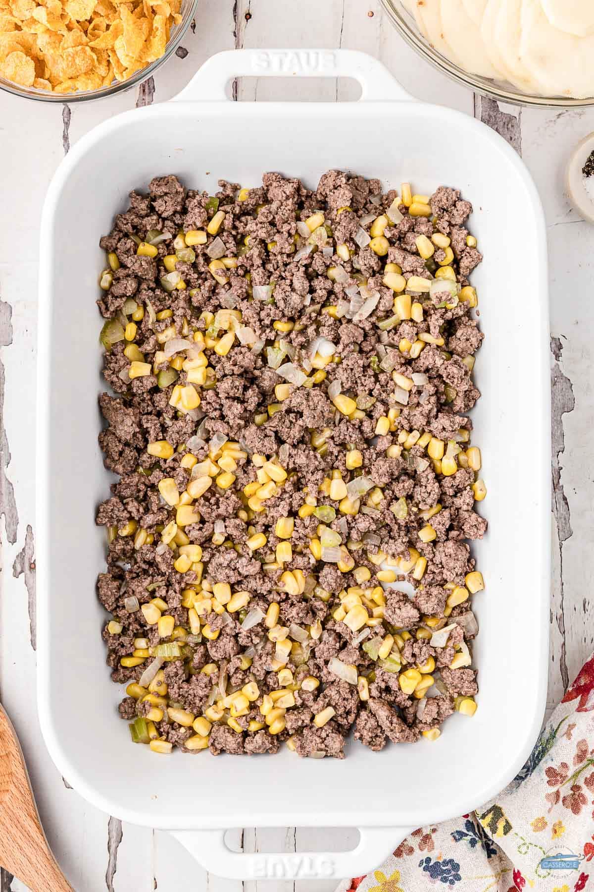 cooked hamburger and corn in a white casserole dish