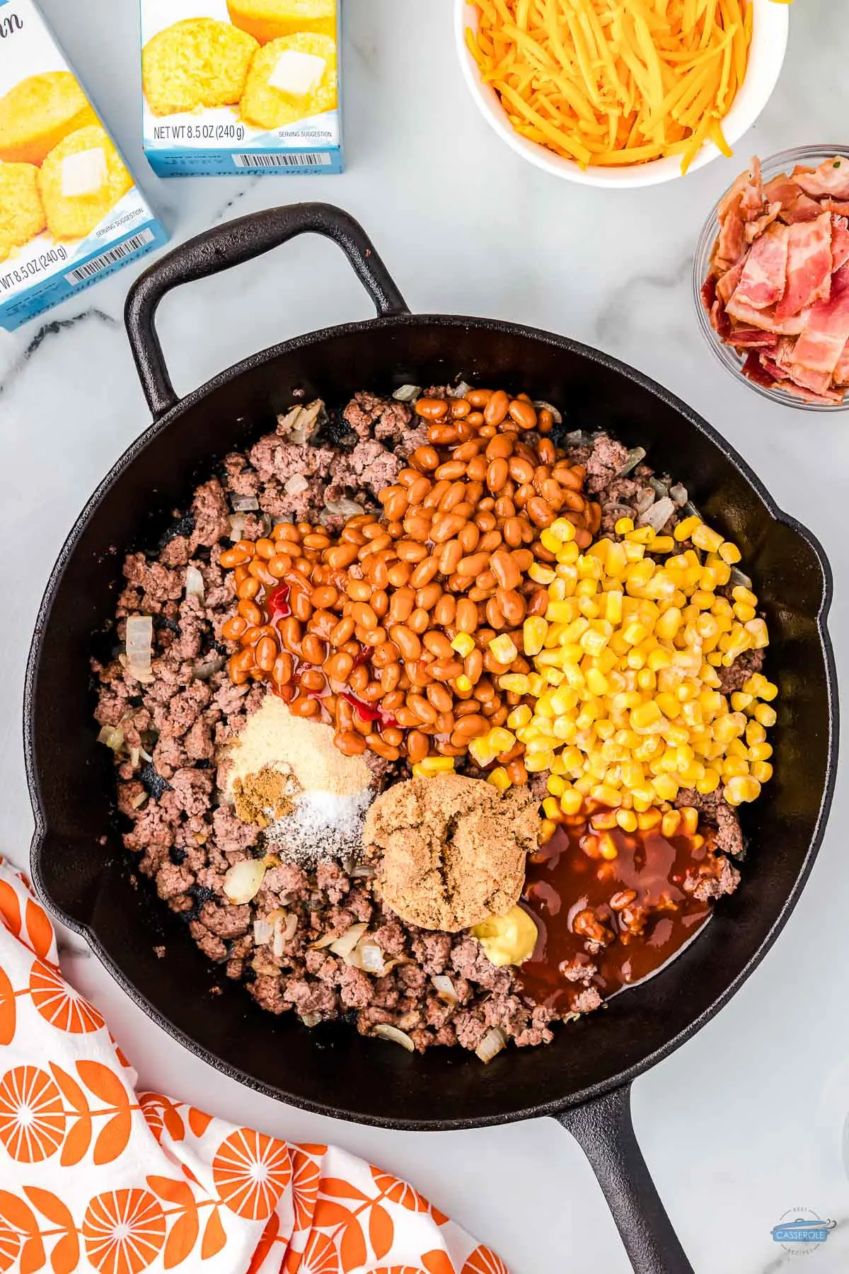 cast iron skillet with ground beef, beans, and corn