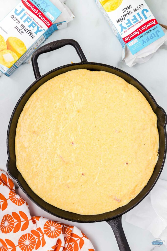unbaked cornbread in a cast iron skillet