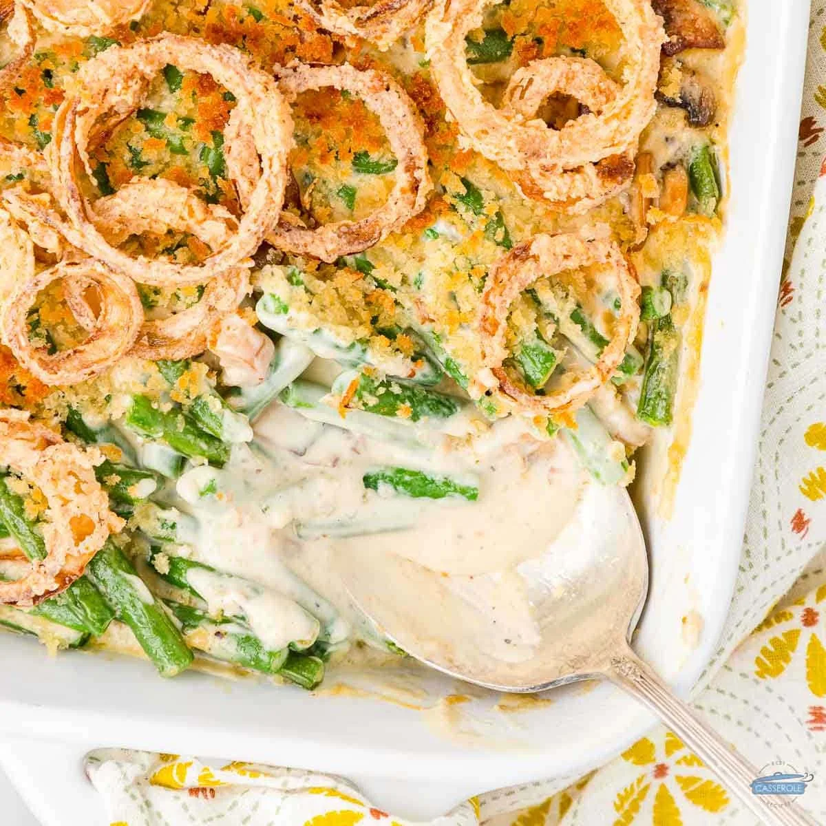 overhead picture of green bean casserole with spoon and scoop missing