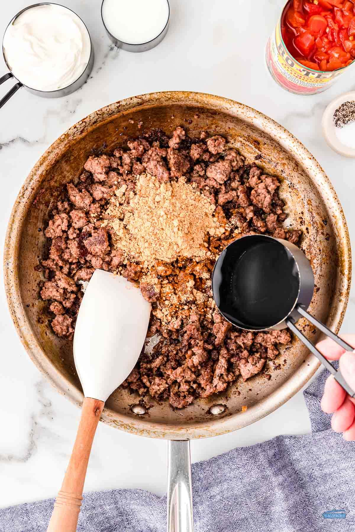 ground beef in a skillet with a spatula
