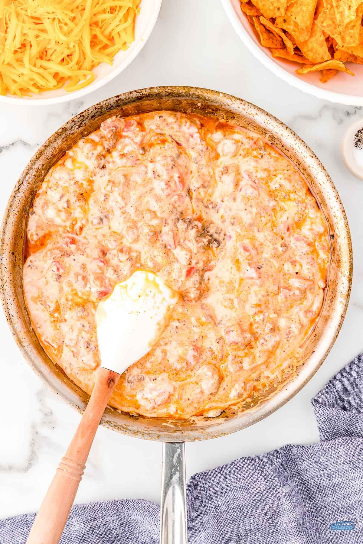 casserole mixture in a skillet with a white spatula