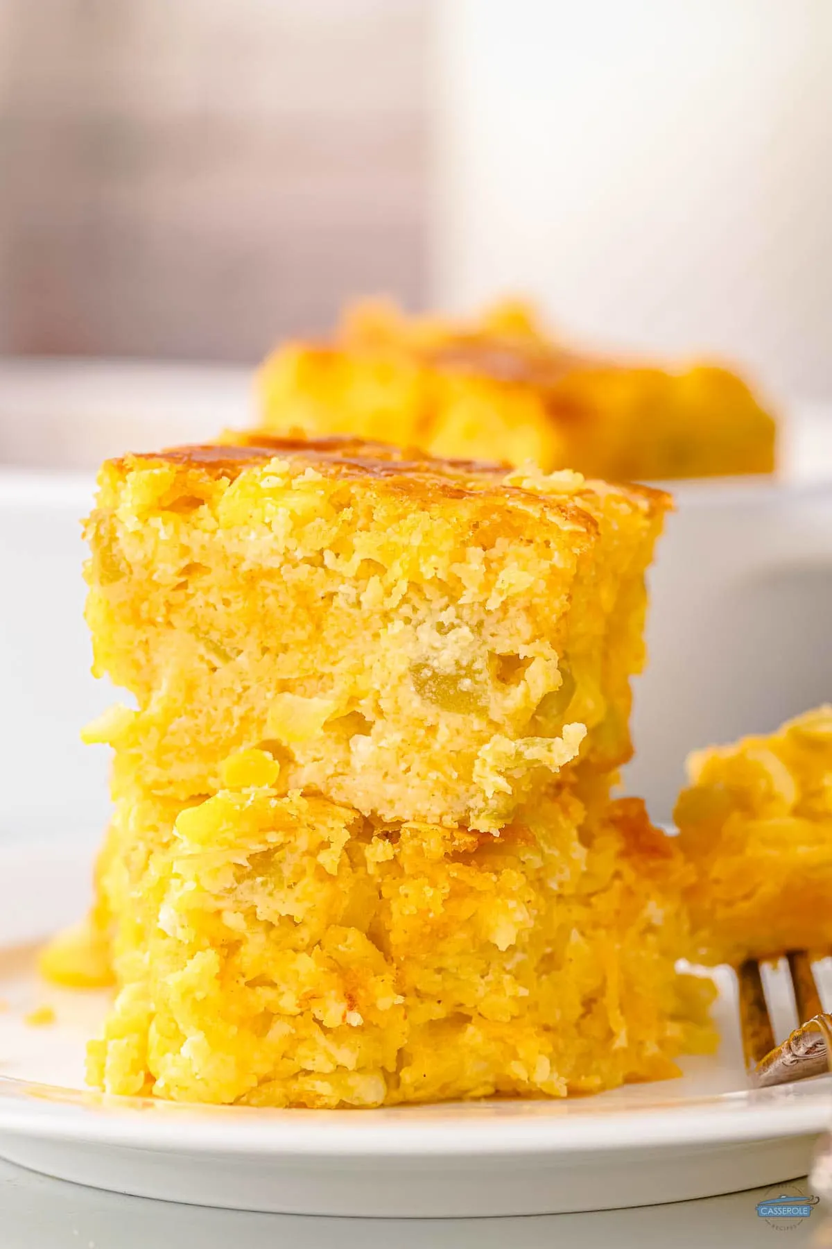 stack of cornbread casserole pieces on a white plate