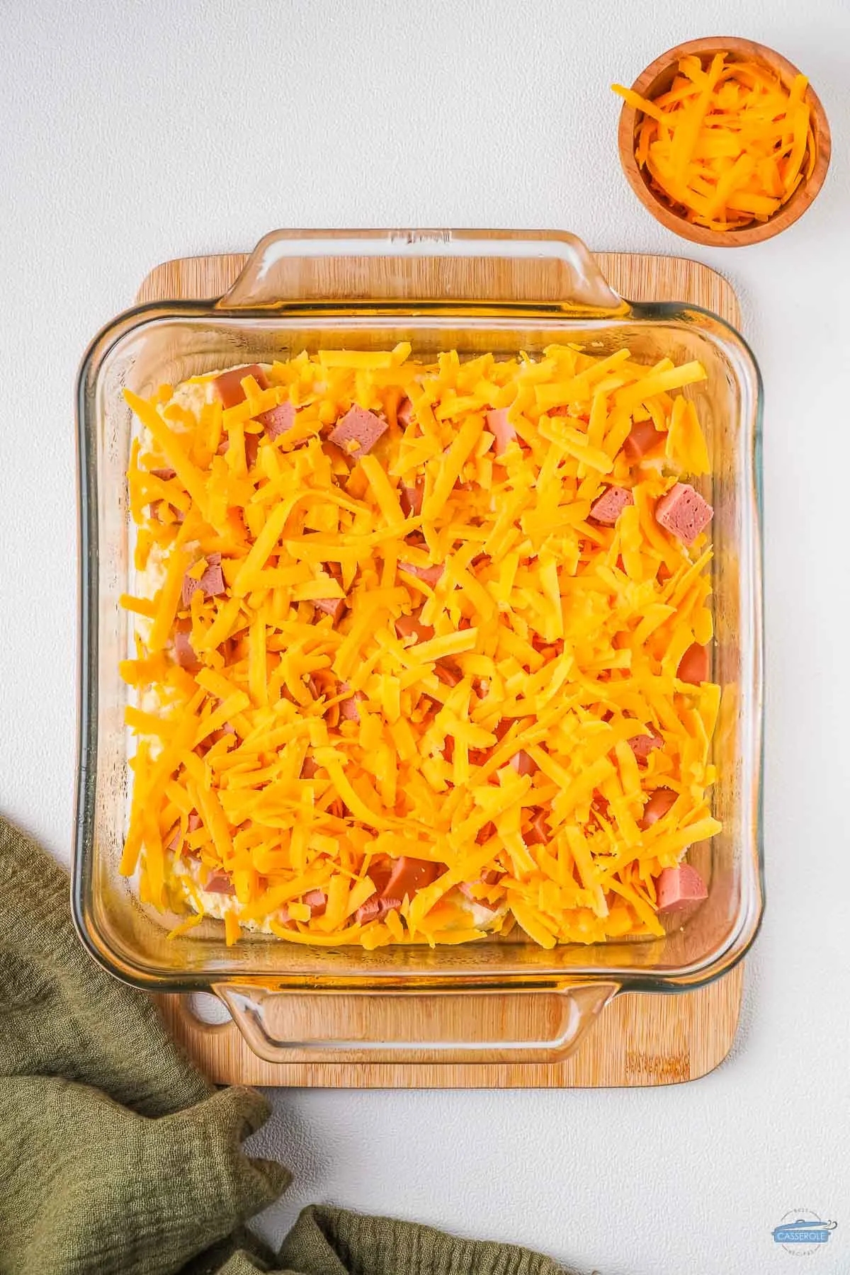cup of cheddar cheese in a casserole dish
