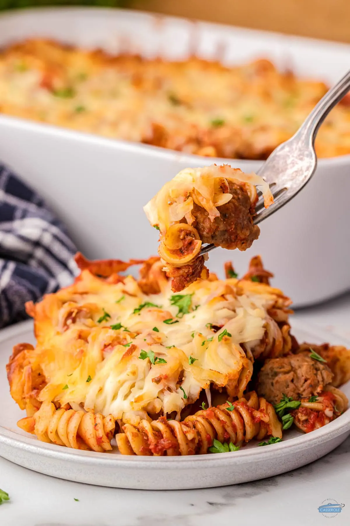 fork of pasta and meatball casserole with parsley