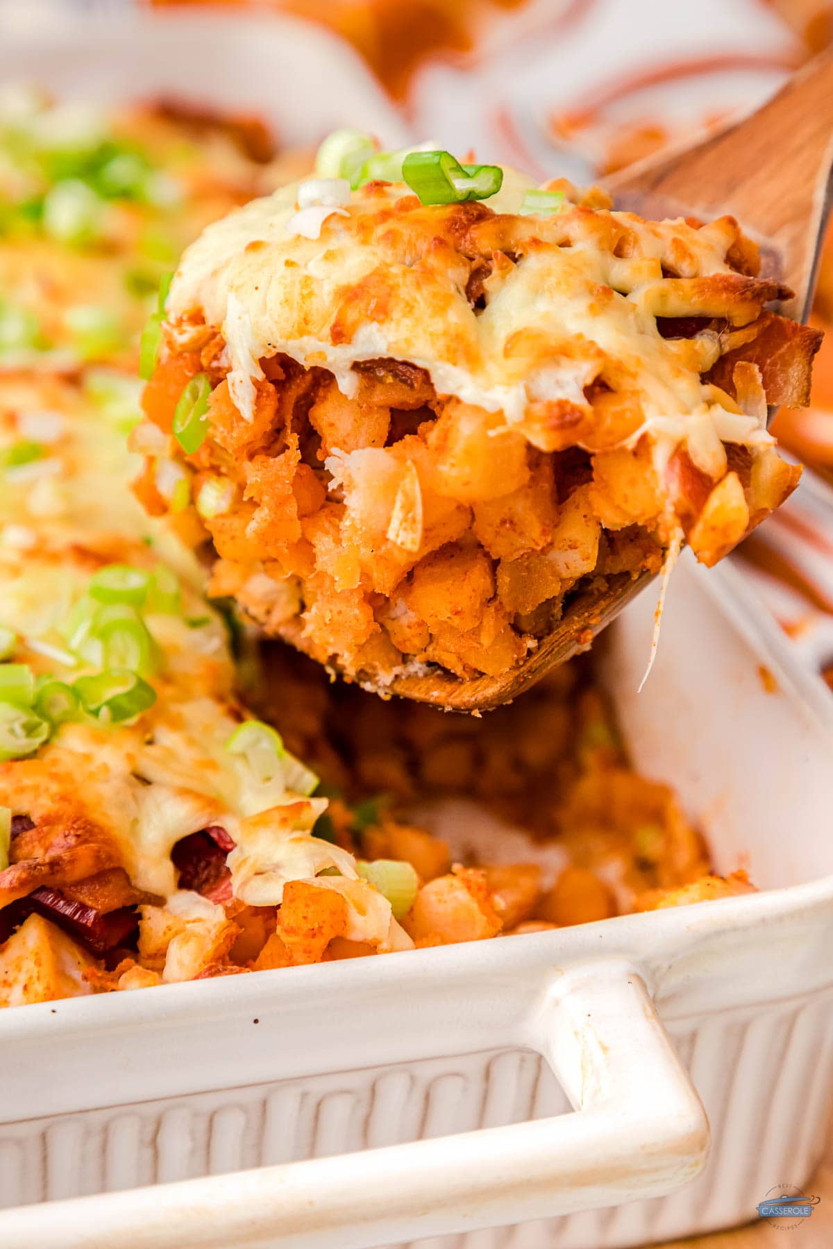 loaded potato and buffalo chicken casserole being scooped out