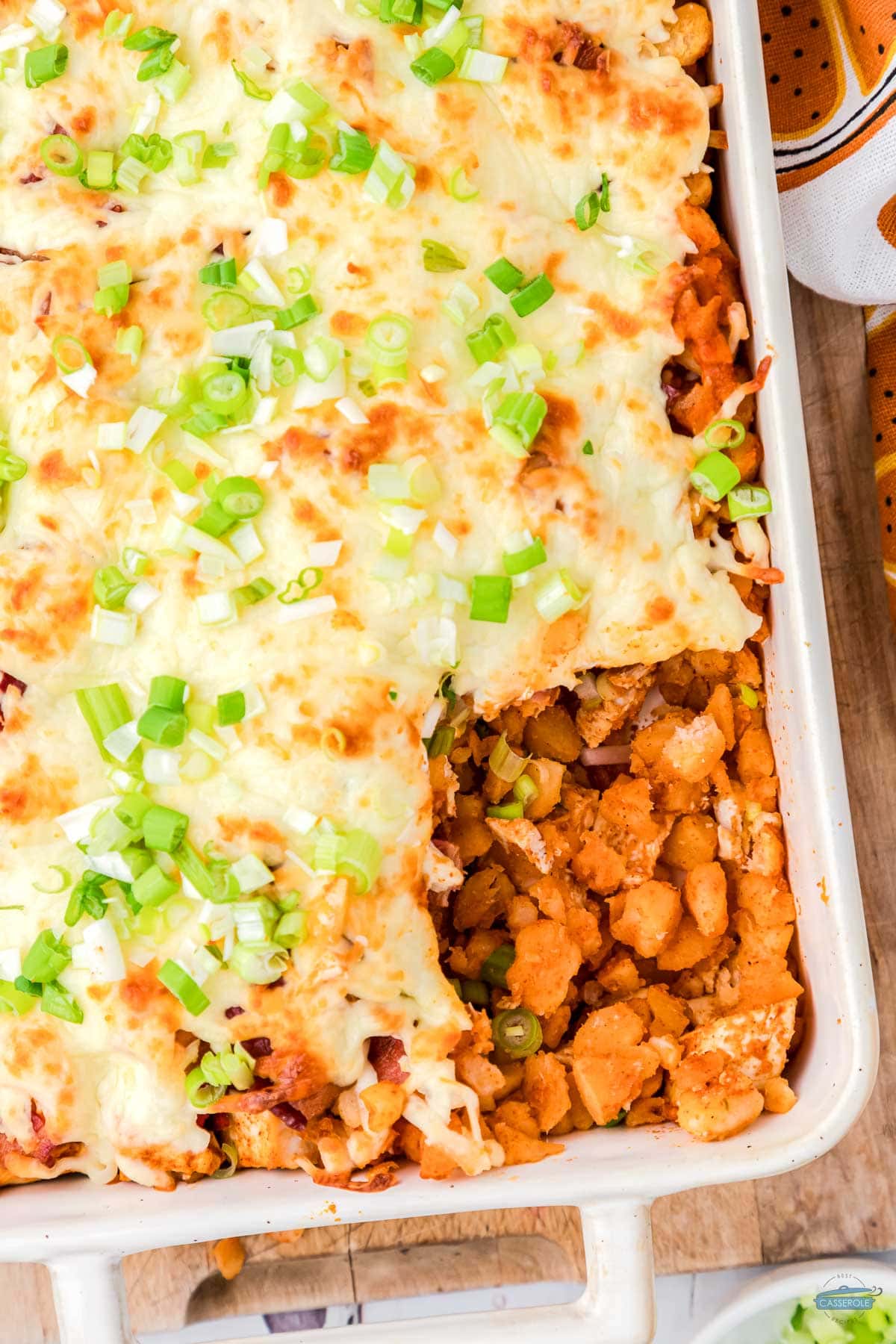 overhead picture of buffalo chicken casserole with scoop missing