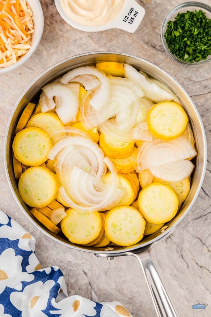 squash and onions in a pot to be cooked