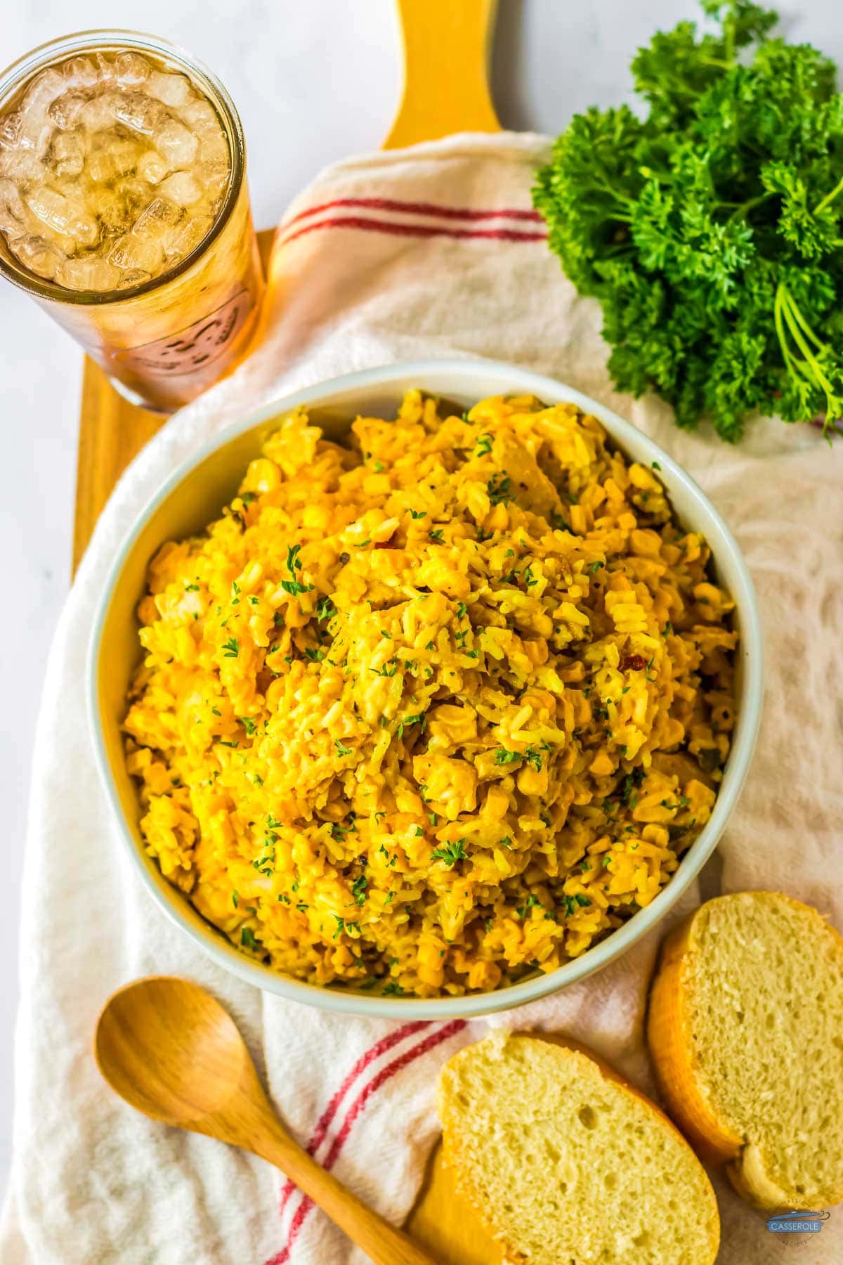 rice casserole recipe in a bowl with two slices of bread