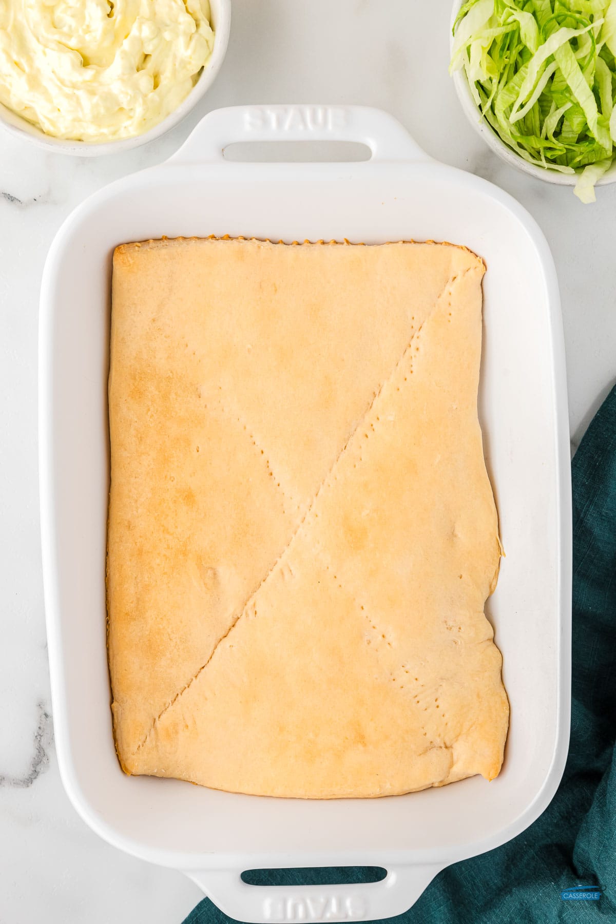 crescent roll dough sheets baked in a large casserole dish