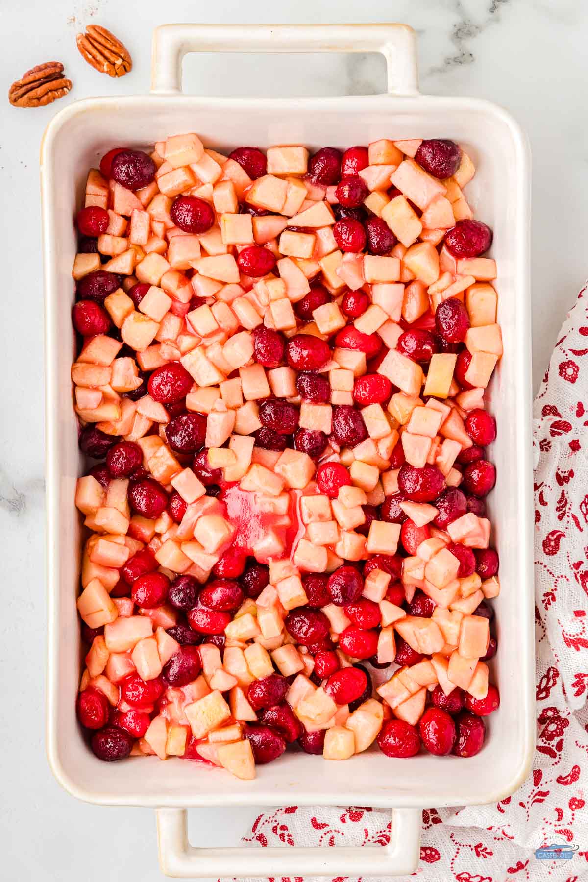 apples and cranberries in a baking dish