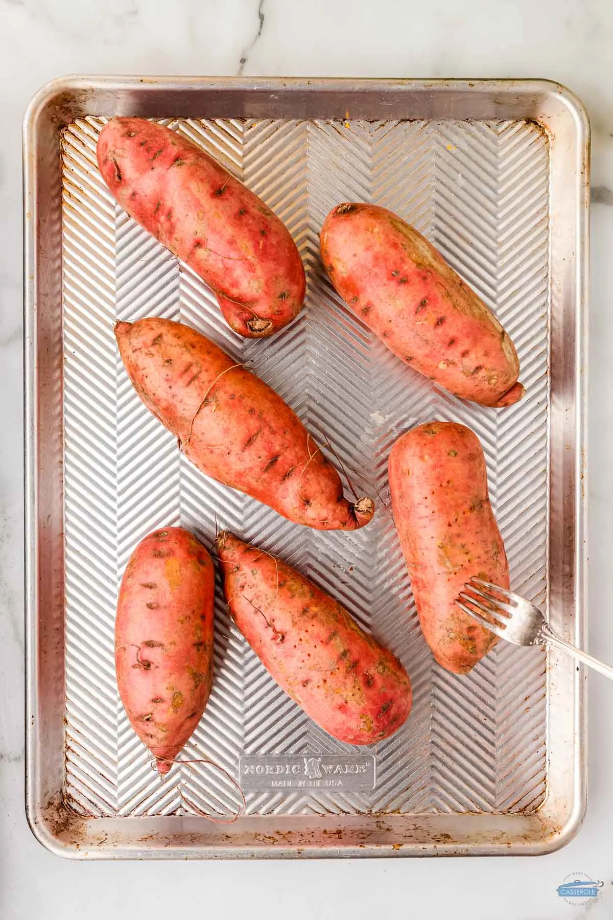 sweet potatoes on a sheet with parchment paper