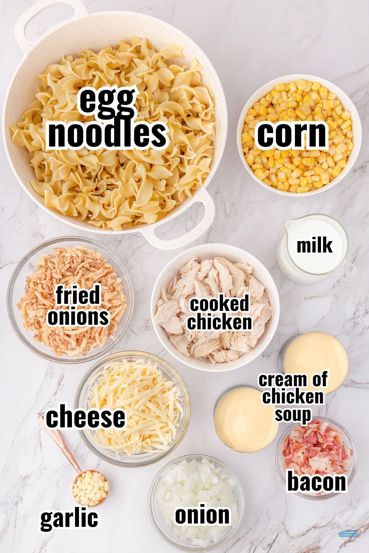 labeled ingredients for a chicken casserole on a marble background