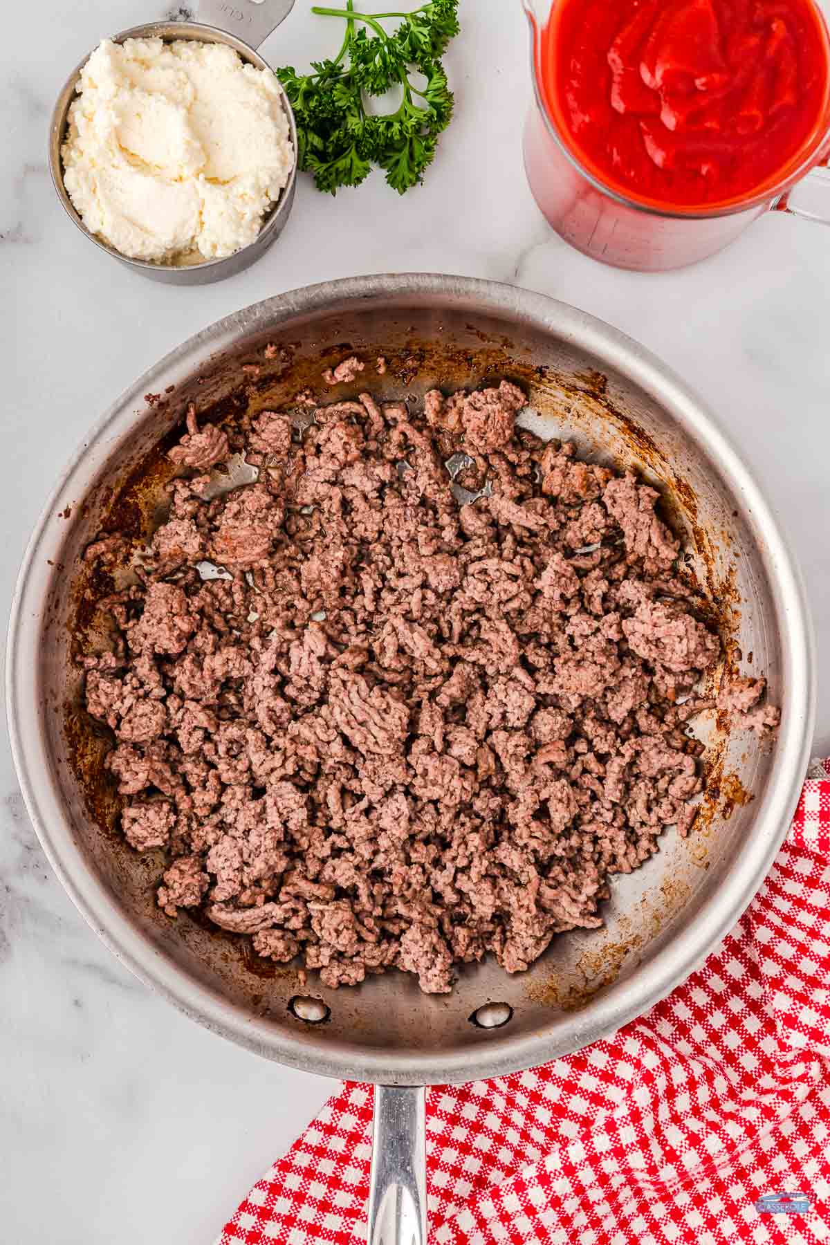 ground beef browning over medium heat in a skillet