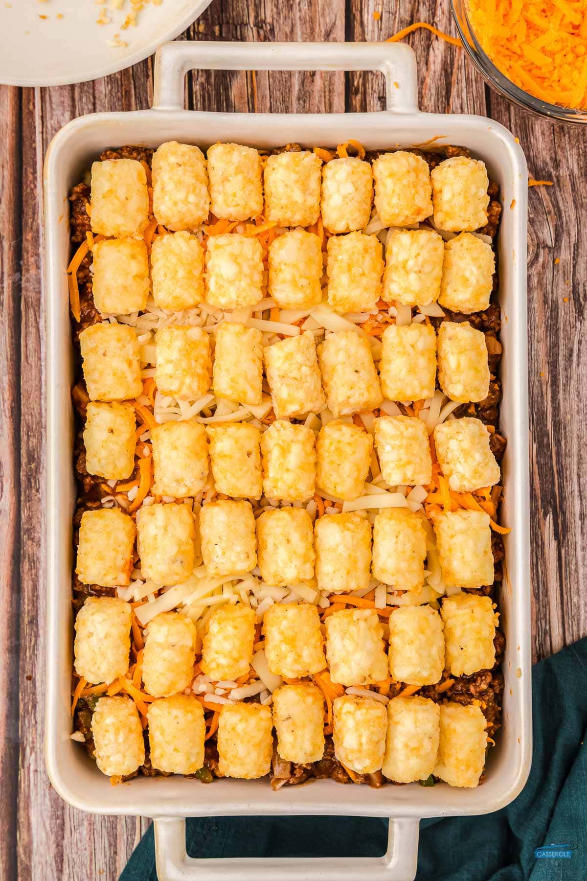 top with remaining cheese and tots
