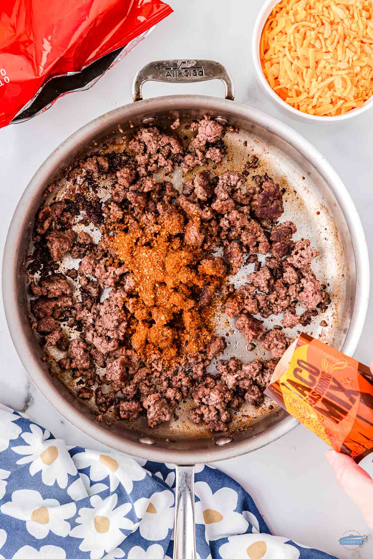 ground beef cooking in a pan with taco seasoning