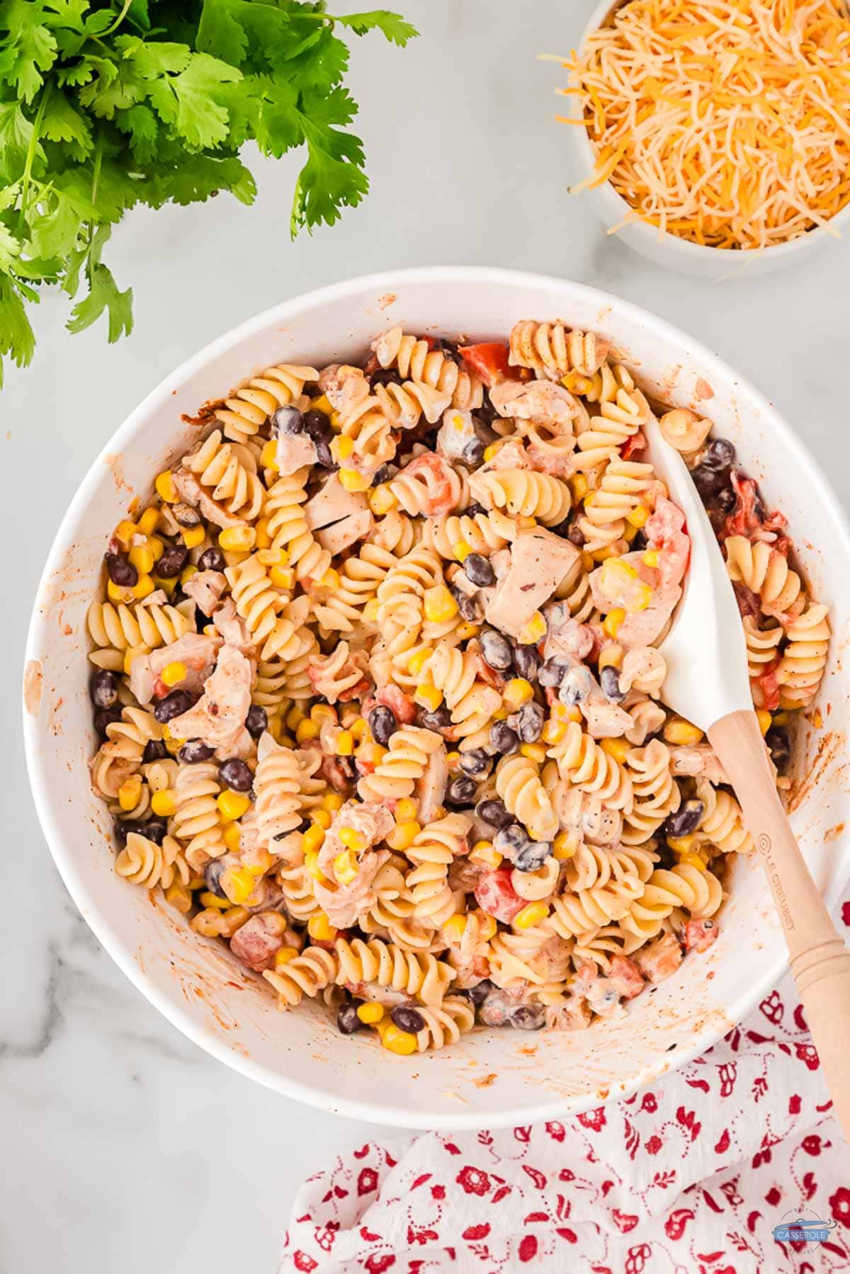 bowl of casserole ingredients mixed together with a spoon