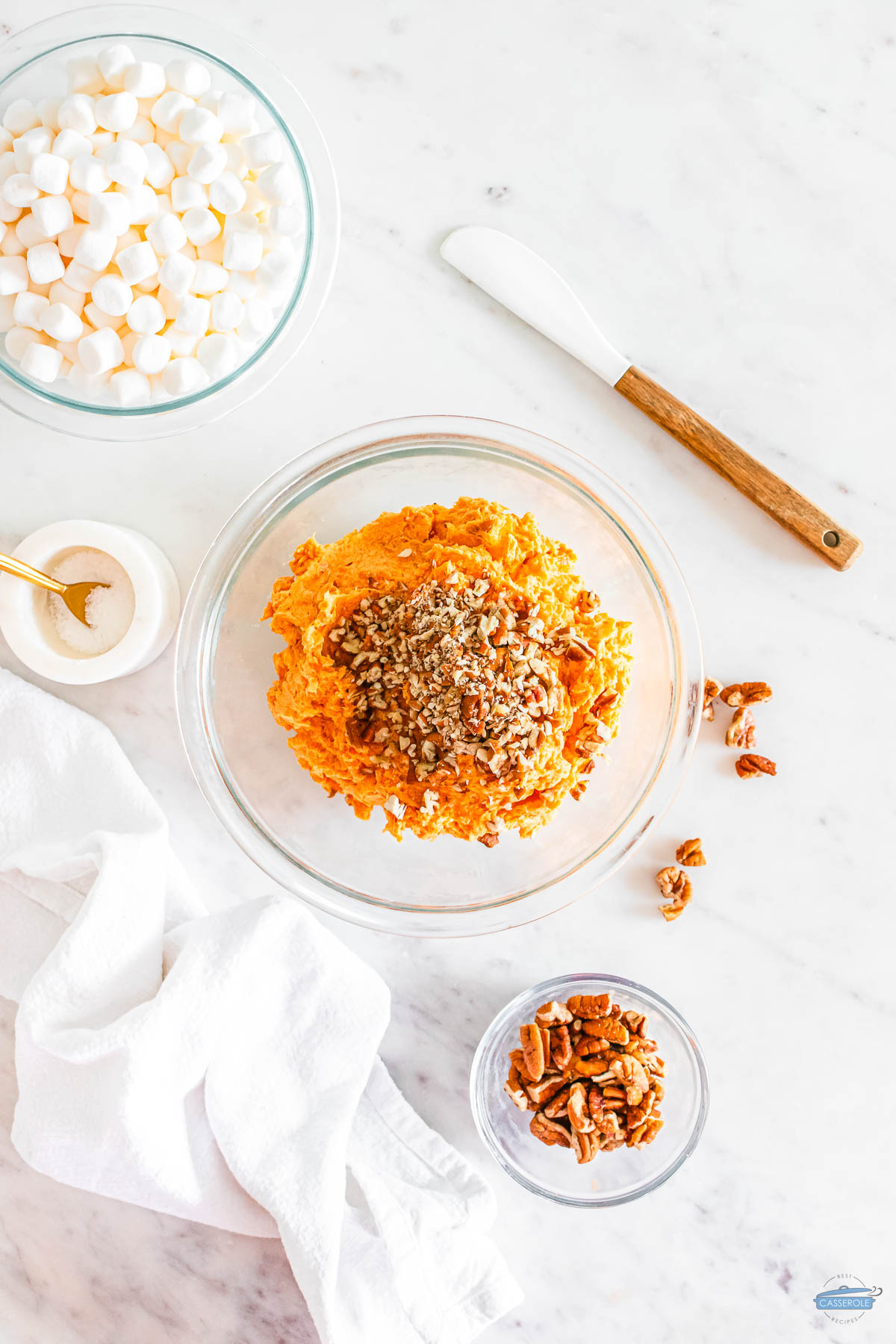 mashed sweet potatoes in a bowl with pecans on top