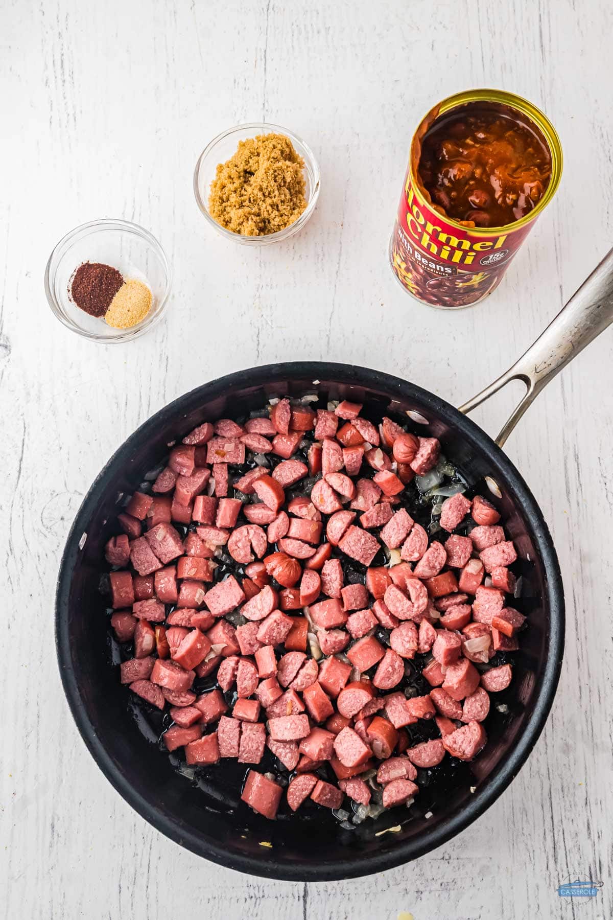 sliced hot dogs cooking in a pan